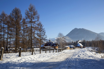 A small church in russian village Zamulta in winter in Uimon Valley, Altai mountains.