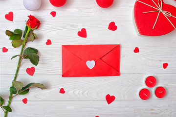 Valentines Day background with a  red rose, a gift and an envelope with a heart.	