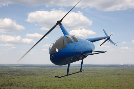 Aircraft - Blue Helicopter flight sky and clouds background
