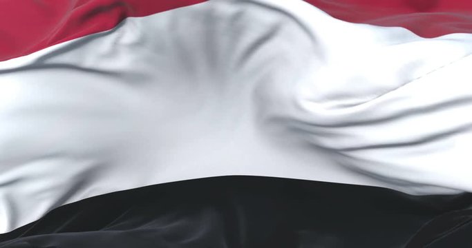 Yemen flag waving at wind in slow with blue sky, loop
