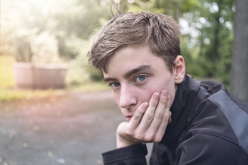 Portrait of a young man who is resting his head on his hand