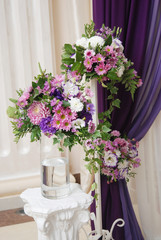 Three Purple and Pink Wedding Arrangement Flower Arrangement. Wedding Day. Vase with flowers. Vertical Image.