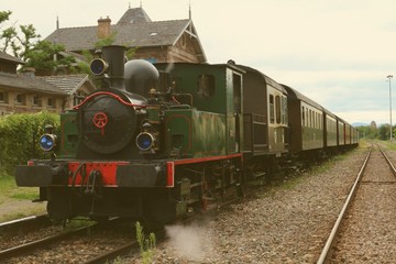 Fototapeta na wymiar Restored historic steam engine train at station in retro look