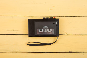 Vintage tape recorder on the yellow wooden desk, journalism investigation concept