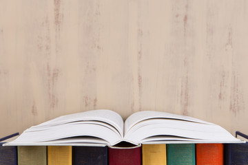 Education and reading concept - group of colorful books on the wooden table
