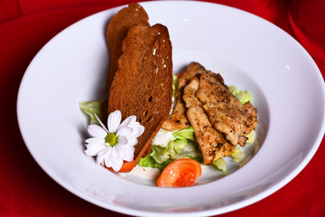 Dinner served on traditional plate. Main meal with bread