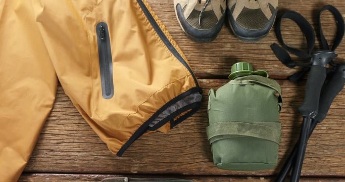 Various travel equipment placed on wooden floor  