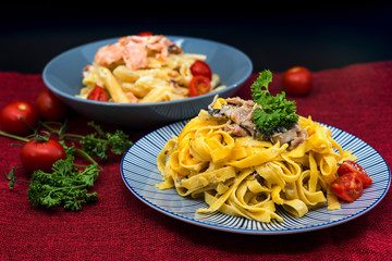Pasta with pesto sauce and Mushrooms on a the table