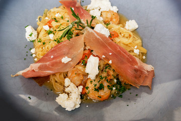 tasty pasta with roast ham on the table
