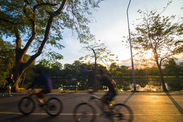 Fototapeta premium People ride a bike in public park
