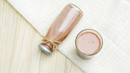 Chocolate milk on a wooden table.