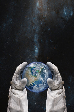 Earth in the hands of astronaut. Earth Day concept. Elements of this image furnished by NASA.