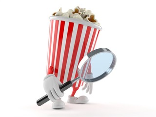 Popcorn character looking through magnifying glass
