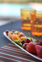 fruit dish and two orange glasses on a cafe table