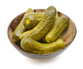 wood bowl with marinated cucumbers on the white