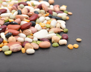 A mixture of legumes , black background.