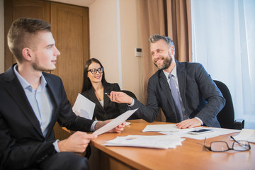 three businessmen at the meeting to communicate