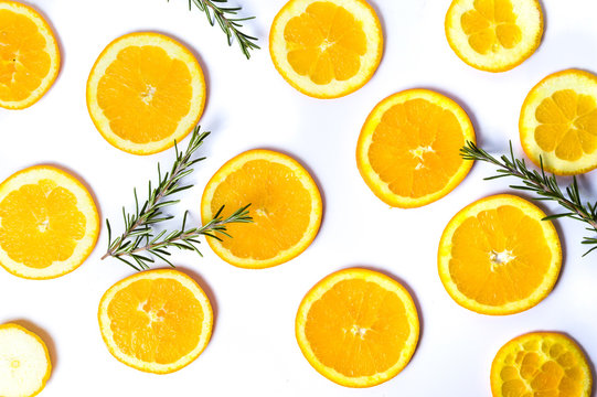 Sliced oranges with rosemary background pattern isolated