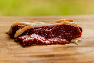 Raw fresh pork meat on cutting board on wooden table