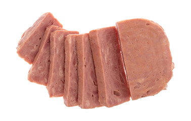 Top view of several thick slices of a whole canned ham isolated on a white background.