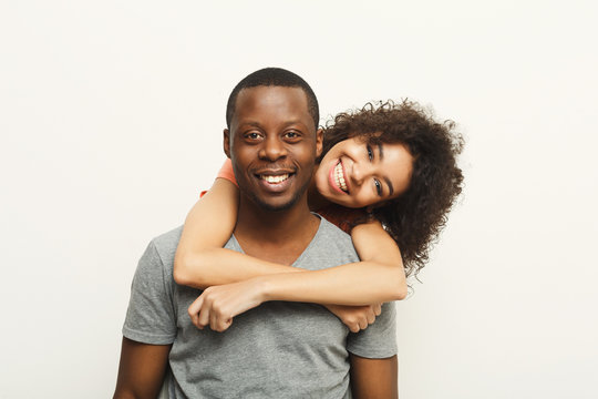 Black Couple Hugging And Posing At White Background