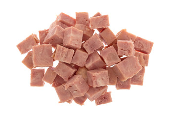 Top view of canned ham that has been cut into chunks isolated on a white background.
