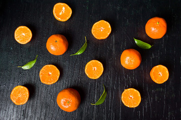 Sliced tangerine on a wooden table top view