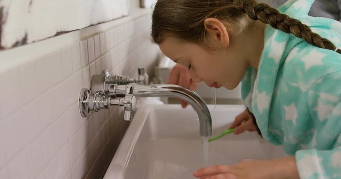 Father and daughter brushing off their teeth 