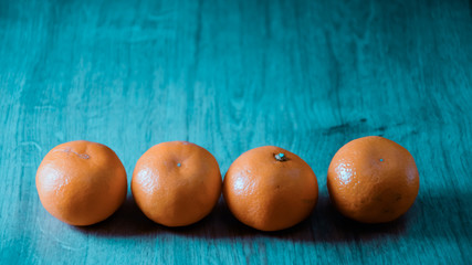 A composition of fresh mandarins on the table in the afternoon