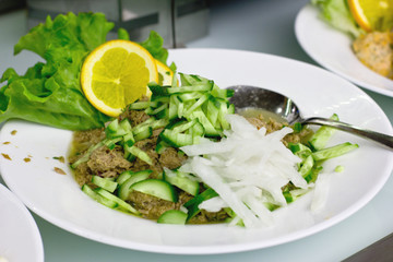 Salad of canned tuna with cucumbers and onions