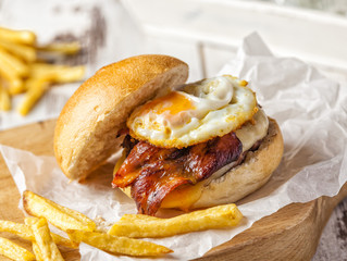 Delicious hamburger with cheese, bacon and fried egg.