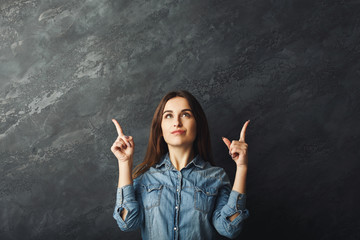 Young girl looking and pointing up