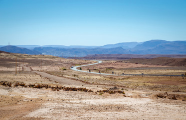 Desert road with Atlas Mountains near Kasbah Ait Ben Haddou, Morocco