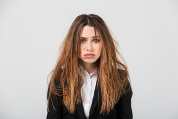 Portrait of an exhausted businesswoman dressed in suit
