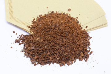 Bean and powder coffee with paper for coffee drip. Cone-type coffee filter for pour over coffee, made of unbleached paper