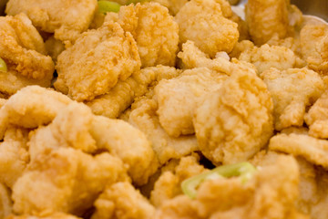 Pieces of fish in brown breadcrumbs decorated with rings of sweet green pepper