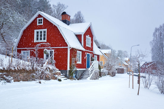 Winter scenery with red wooden house in Sweden