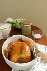 Baked chicken with herbs and garlic, served with sour cream sauce. Rustic style.