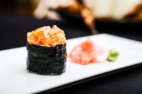 Spicy salmon sushi served on a plate