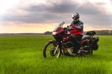 Fototapeta na wymiar Motorcyclist on mountainous highway, cold overcast weather, Europe, Austria, Alps, extreme sport, active lifestyle, adventure touring concept