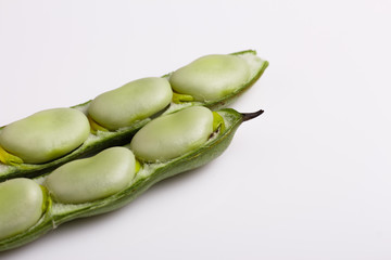 fresh broad beans on a white background