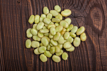 fresh broad beans on a rustic background