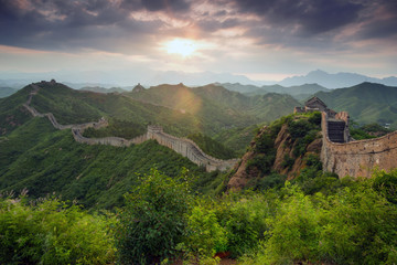 Sunset in a dark, stormy, dramatic sky over the Great Wall of China at the Wild Wall, Jinshanling, near Beijing