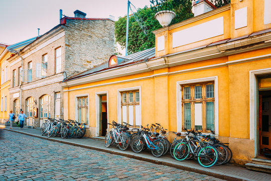 Fototapeta Tallinn, Estonia. Bicycles Rental Bikes Parking Near Old House