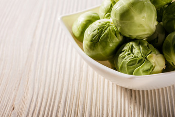 Brussels sprouts on a rustic wooden background