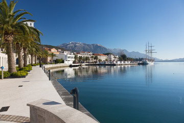 Fototapeta na wymiar Embankment in Tivat, view of an old sailing ship. Montenegro