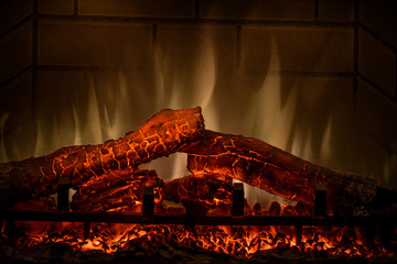 Close up of electric fireplace with orange and yellow fire flame