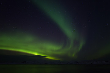 Aurora Borealis (Northern Lights) above coastal sea