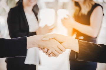 Business people shaking hands after finish reach agreement for startup new project. Negotiating and Happy working concept. Handshake gesturing connection deal concept. People and teamwork theme