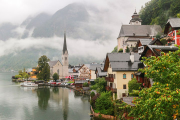 Scenic view of famous Hallstatt mountain village in the Austrian Alps with misty raining, Salzkammergut region, Austria